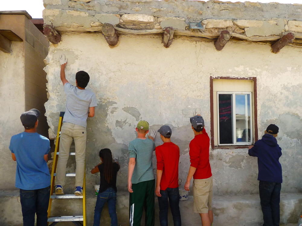 Participants plastering buildings in Hopi Pueblo