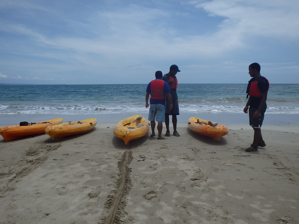 Preparing sea kayaks for launch in Costa Rica