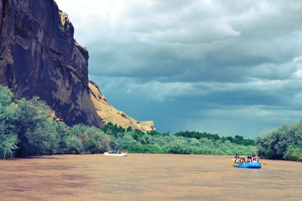 The Canyon walls scale down at Deer Hill participants while rafting the San Juan River