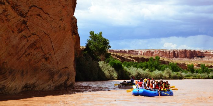 Deer Hill raft floats near a canyon wall