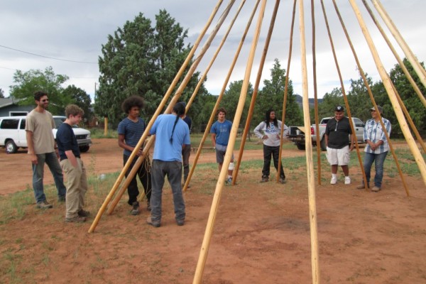 Deer Hill participants help construct a teepee