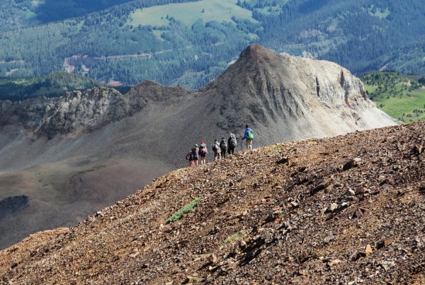 Teens hiking in the Four Corners wilderness during a Deer Hill summer program