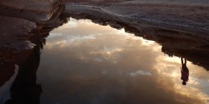 Sunset reflected in puddle near Native American service project site with Deer Hill Expeditions