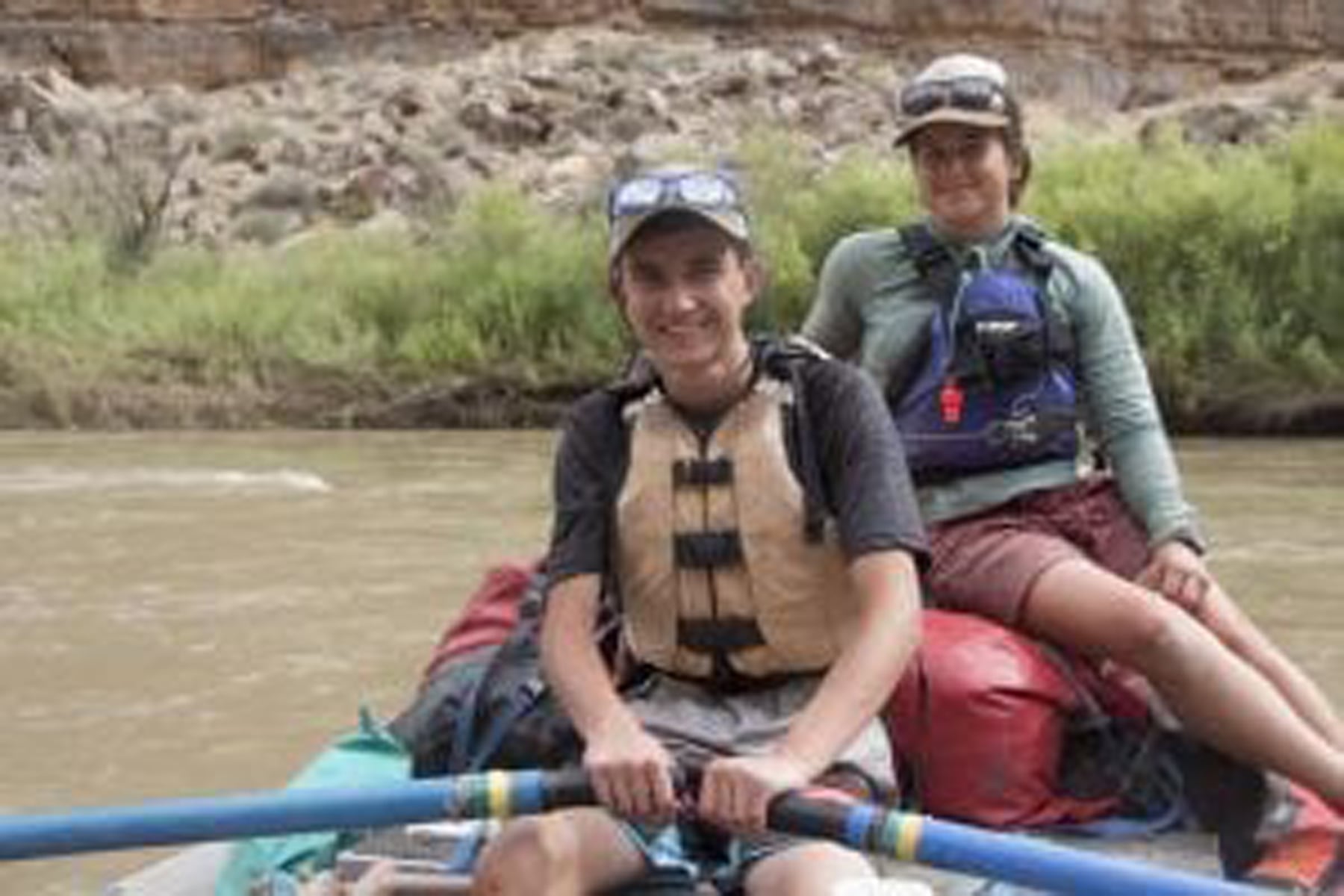 two teen boys on a raft on colorado river with deer hill expeditions summer camp