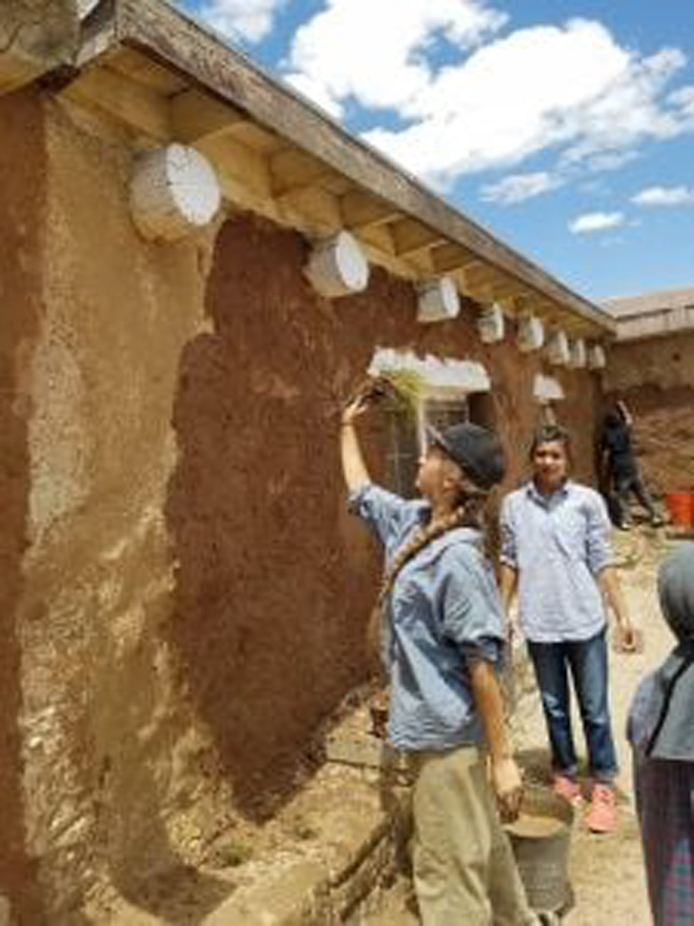 A group works on a building at service